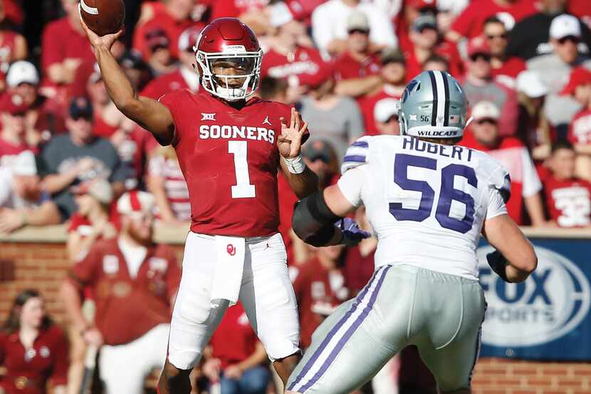 Oklahoma quarterback Kyler Murray (1) passes under pressure from Kansas State defensive end...