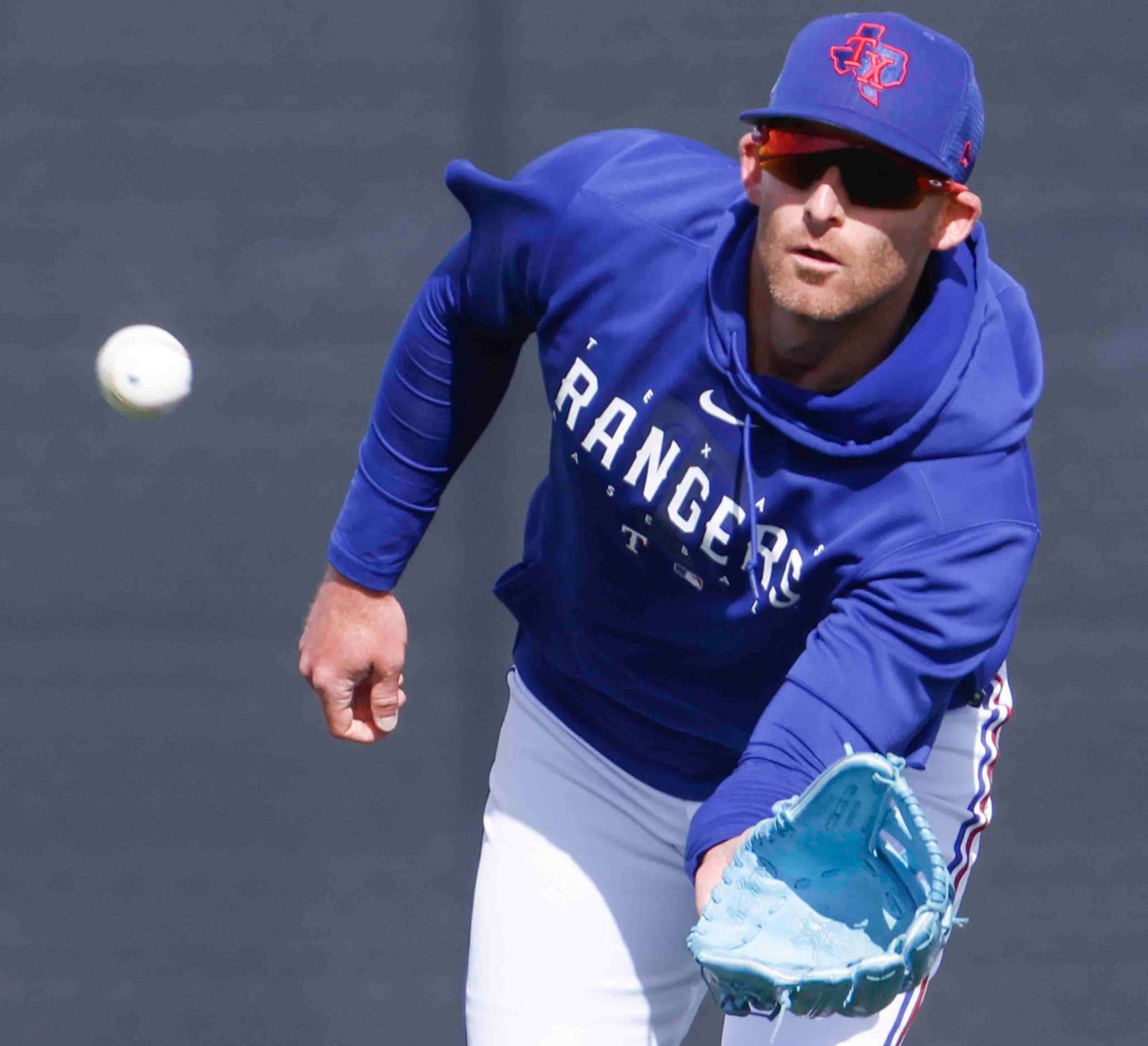 Texas Rangers outfielder Brad Miller catches a ball during a spring training workout at the...