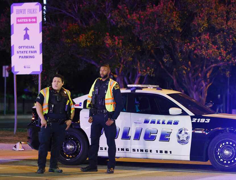 Dallas police stand guard after a shooting at the State Fair of Texas on Saturday, Oct. 14,...