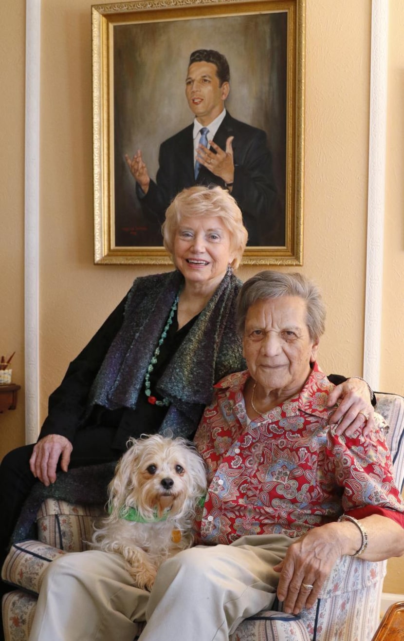 
Emily and Homer Martinez pose in their Dallas home with their dog, Scruffy on Friday,...