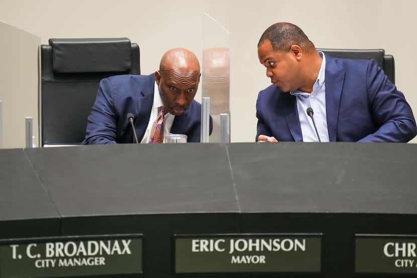 Dallas City Manager T.C. Broadnax and Mayor Eric Johnson confer as they listen to public...
