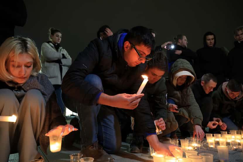 People light candles in memory of the victims of the terrorist attack in Moscow, in the...