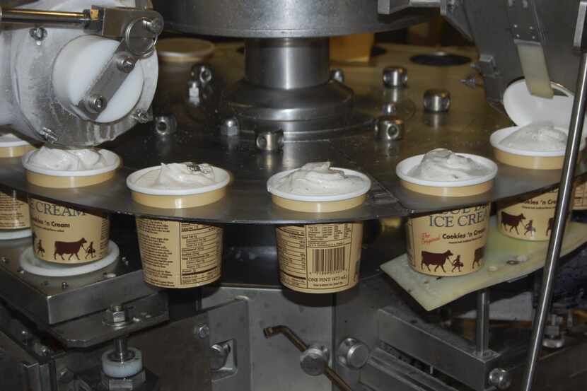  A machine fills cartons of Cookies 'n Cream ice cream at the Blue Bell Creameries...