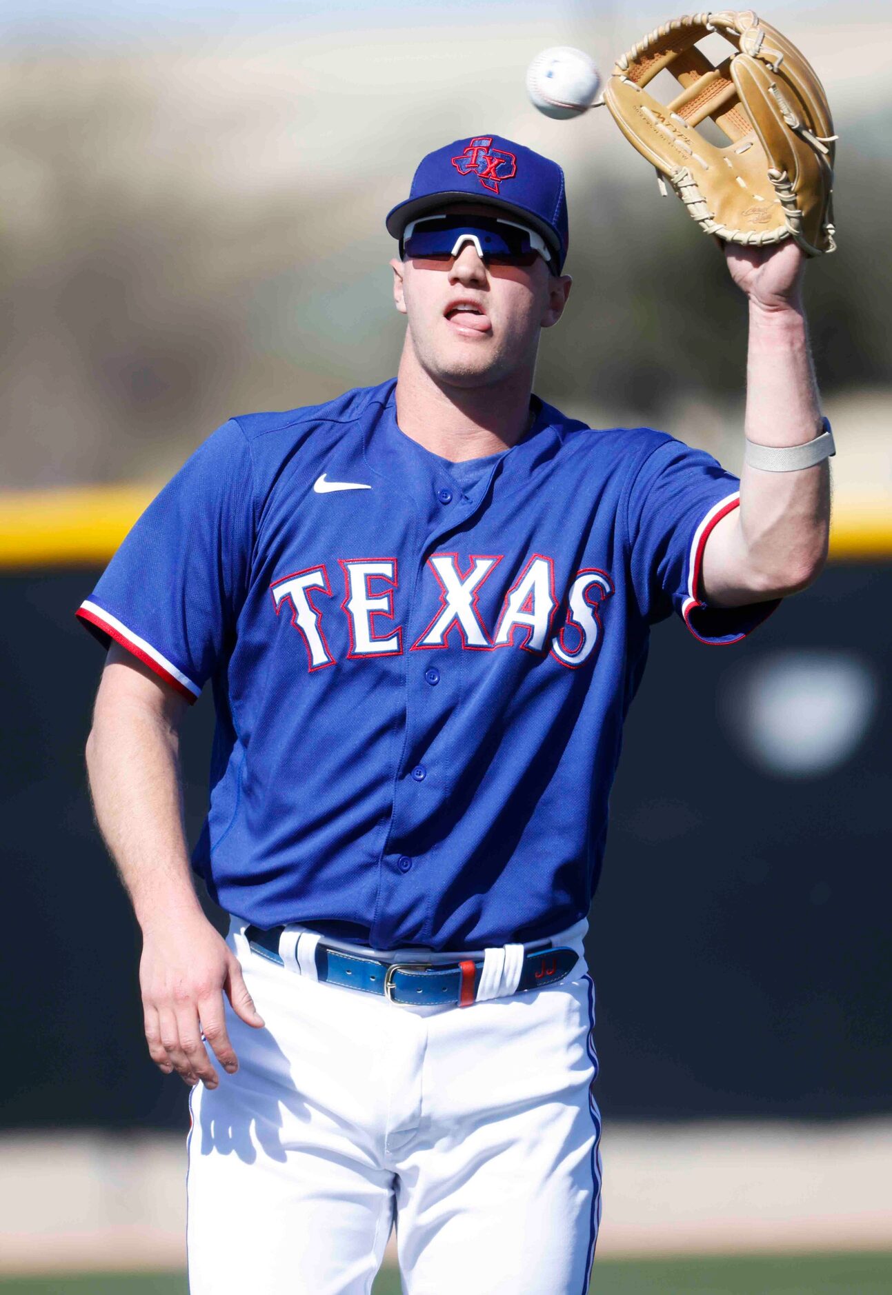 Texas Rangers third baseman Josh Jung warms up during a spring training workout at the...