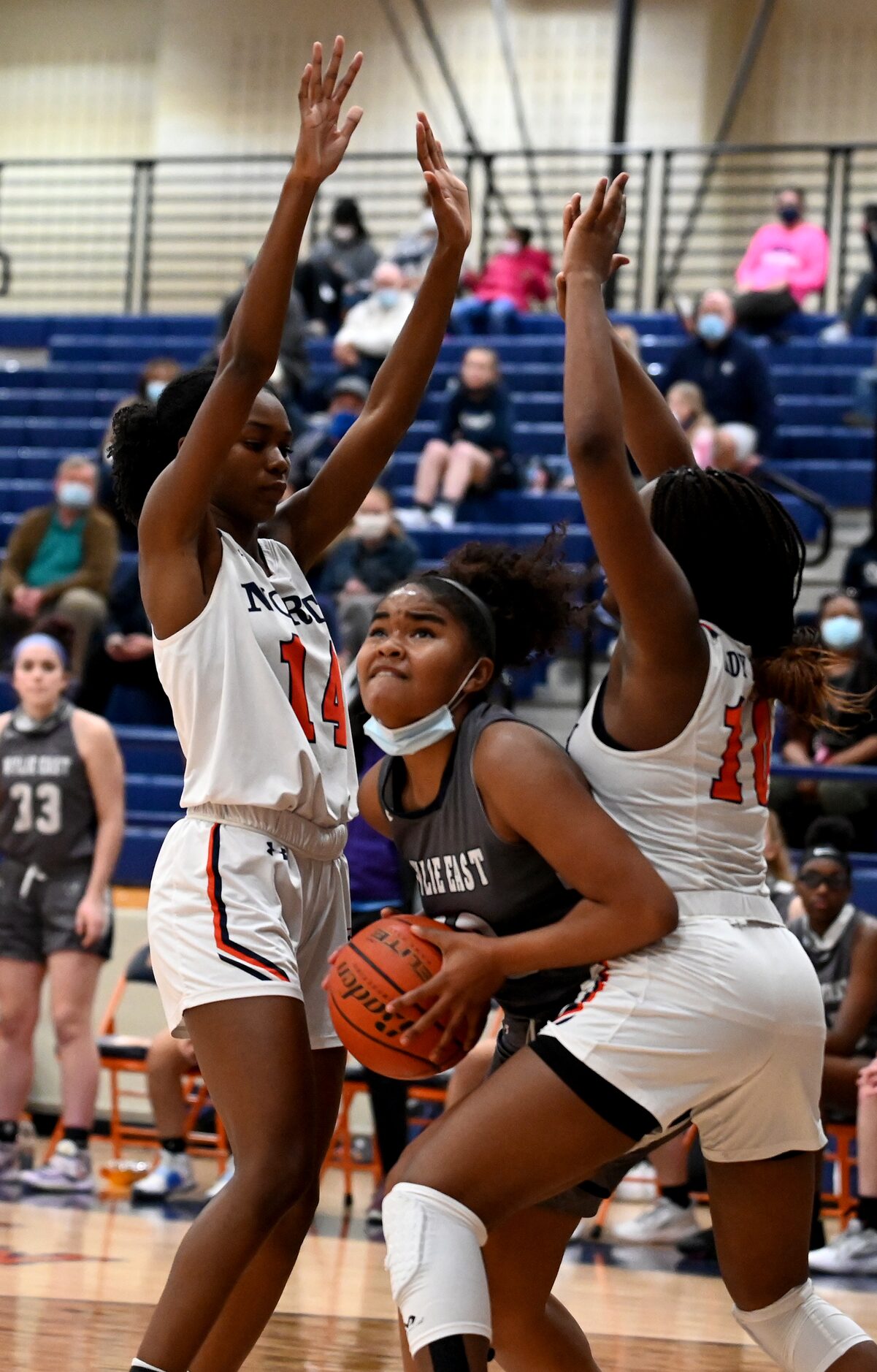 Wylie East’s Keyera Roseby drives to the basket between McKinney North’s Timari Harvey (14)...