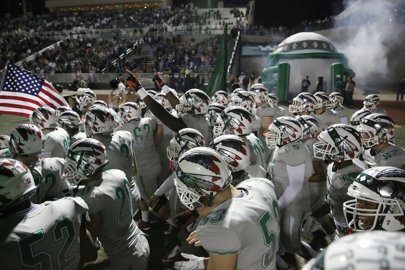 Waxahachie players enter the field before a high school football game between Lancaster and...
