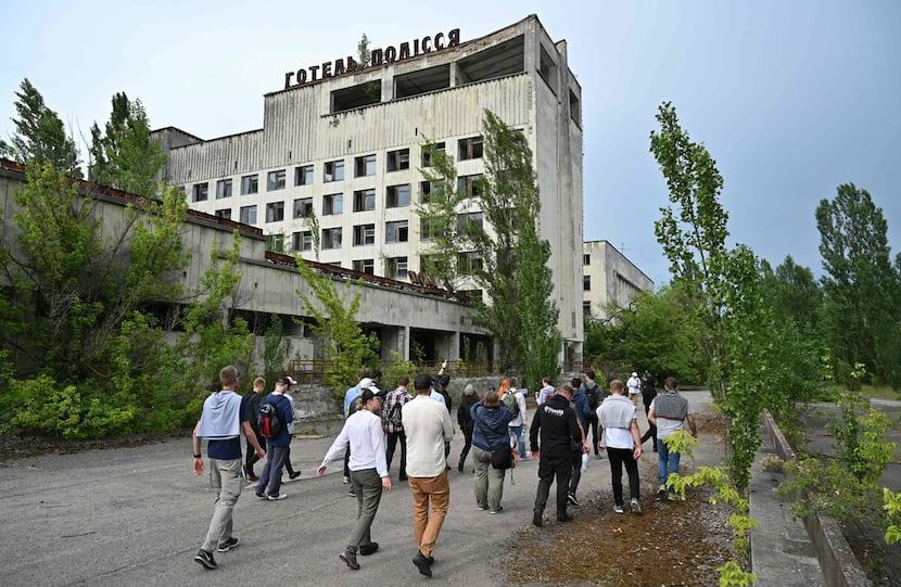 Visitors walk in the ghost city of Pripyat during a tour of the Chernobyl Exclusion Zone....