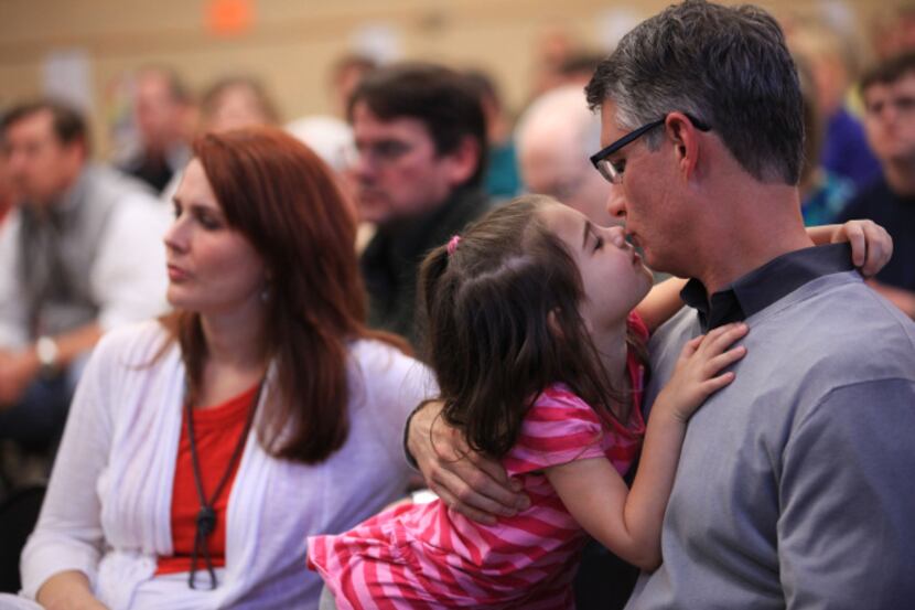 William Rogers got a kiss from his daughter, Sarah, 5, during the Richardson school district...