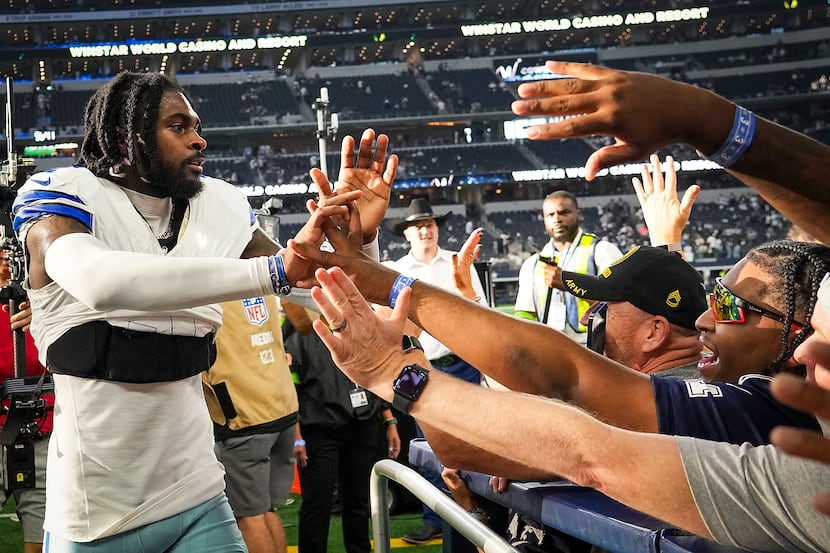 Dallas Cowboys cornerback Trevon Diggs high fives fans after a victory over the New York...
