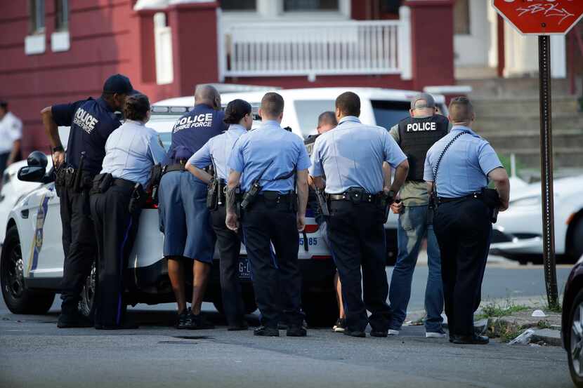 Philadelphia police stage as they respond to an active shooting situation, Wednesday, Aug....