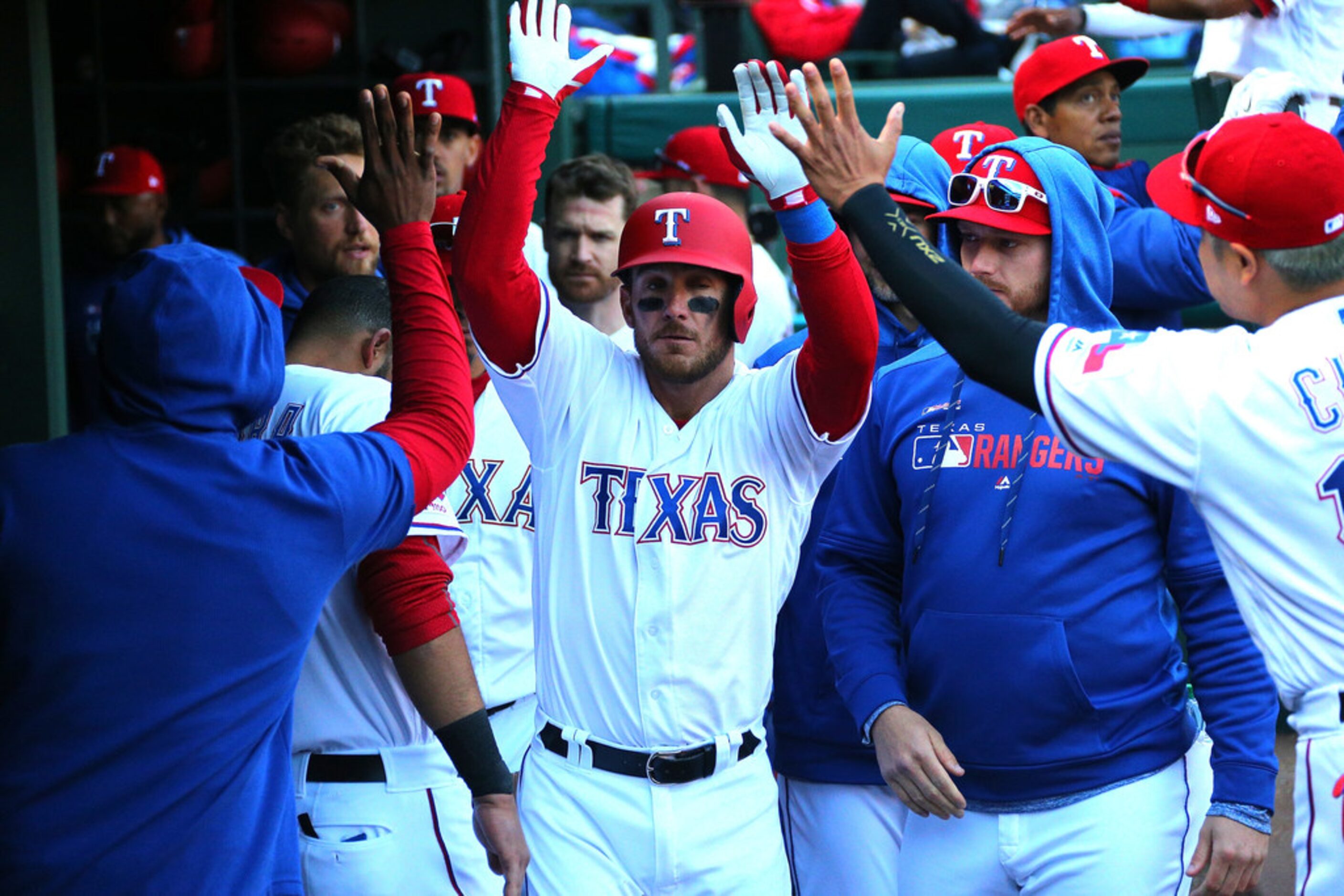 ARLINGTON, TX - MARCH 31: Jeff Mathis #2 of the Texas Rangers is congratulated for hitting a...