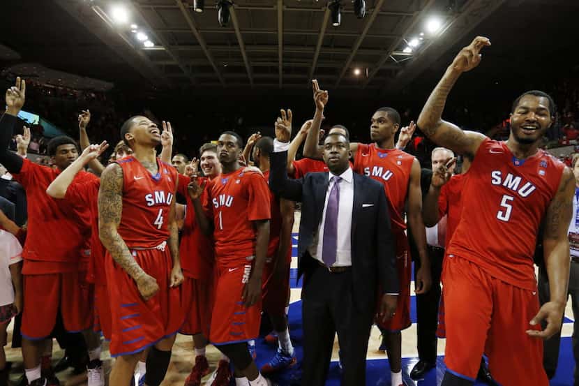 Members of the SMU basketball team, including Keith Frazier (4); guard Ryan Manuel (1) and...