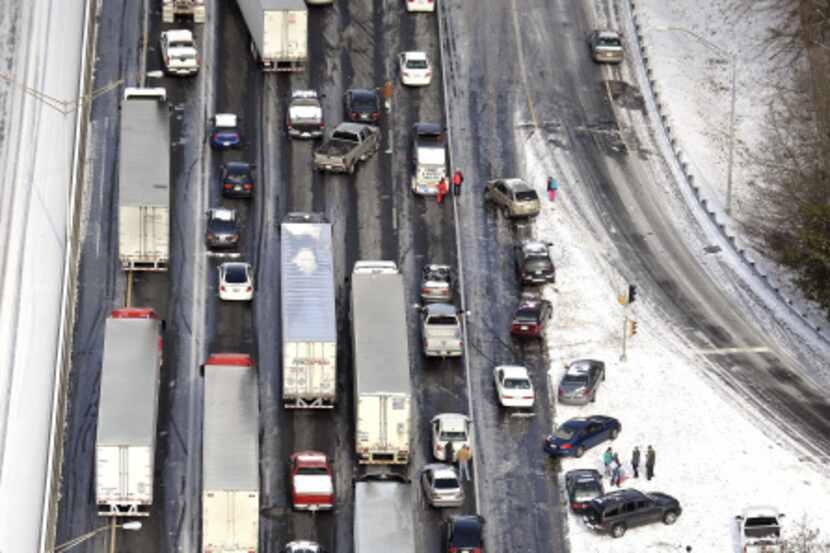 Motorists on Interstate 75 in Atlanta got out of their vehicles to chat near abandoned cars...