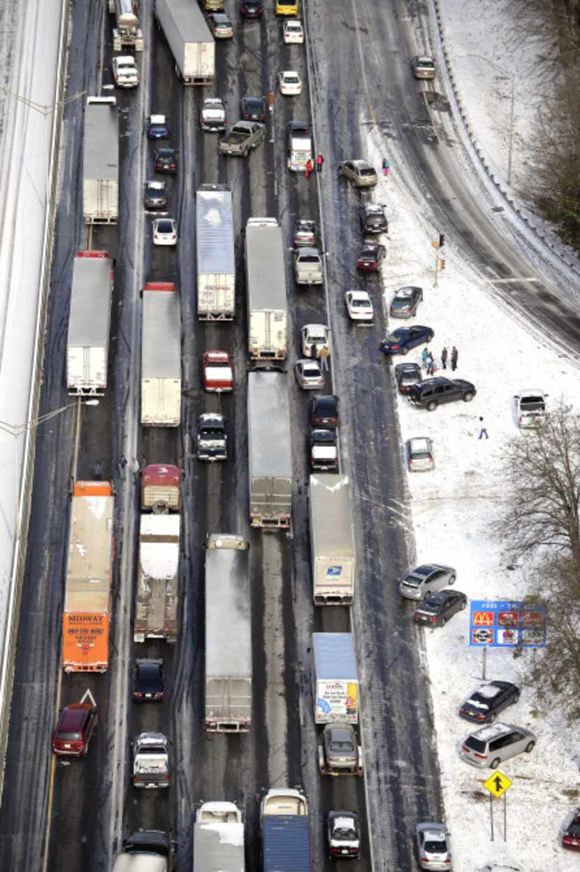 Motorists on Interstate 75 in Atlanta got out of their vehicles to chat near abandoned cars...