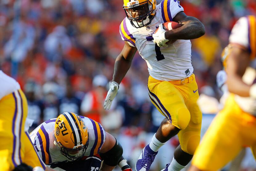 FILE - In this Sept. 24, 2016, file photo, LSU running back Leonard Fournette (7) hurdles an...