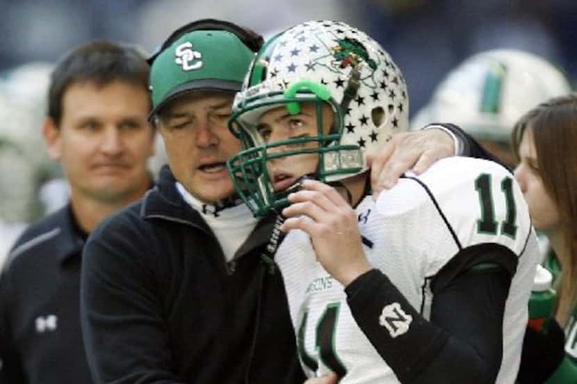 In this photo from 2006, Southlake Carroll's head coach Todd Dodge congratulates his son and...