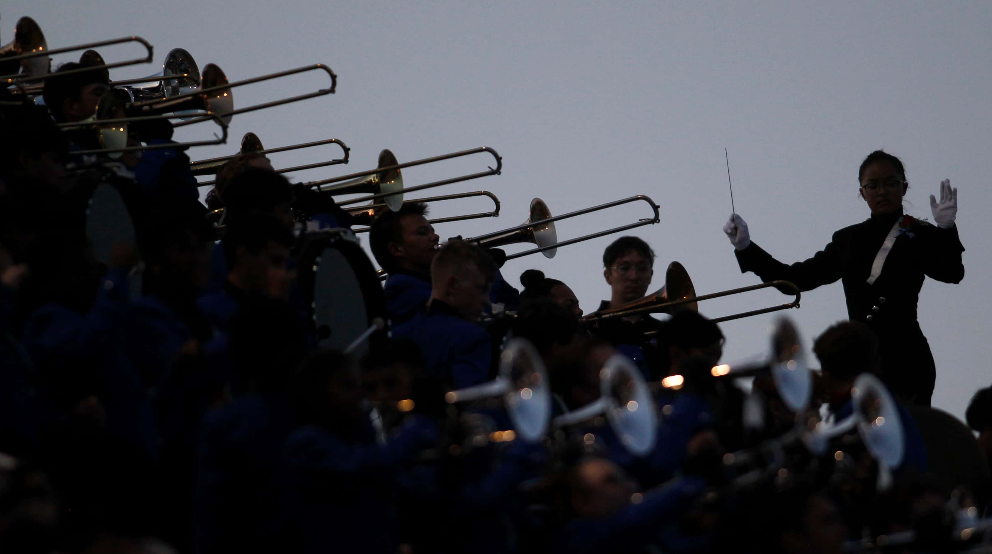 A band squad leader directs members of the Hebron band from the stands during first quarter...