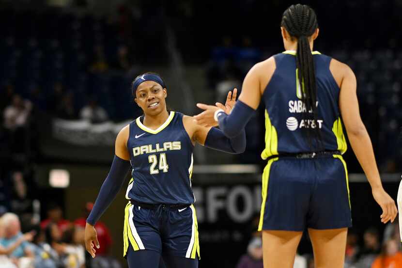 Arike Ogunbowale #24 and Satou Sabally #0 of the Dallas Wings celebrate in the first half...
