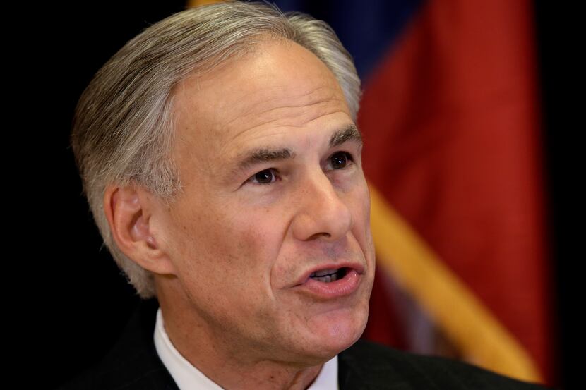 Texas Attorney General Greg Abbott responds to a reporters question during a news...