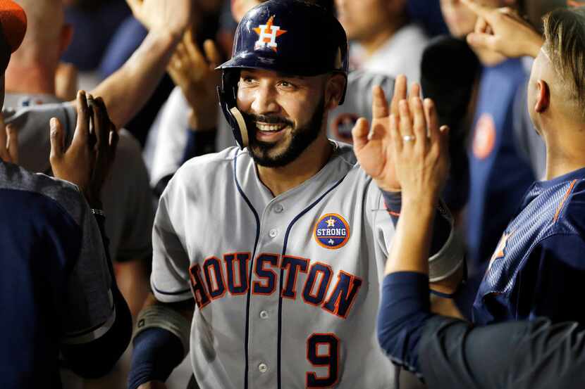 ARLINGTON, TX - SEPT 25: Marwin Gonzalez #9 of the Houston Astros is congratulated by...