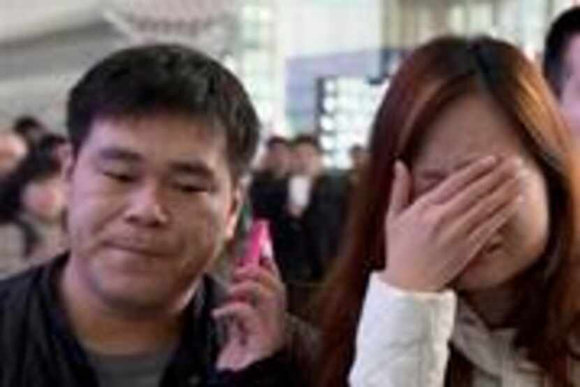 ALTERNATE CROP OF XHG102 A woman cries at the arrival hall of the International Airport in...