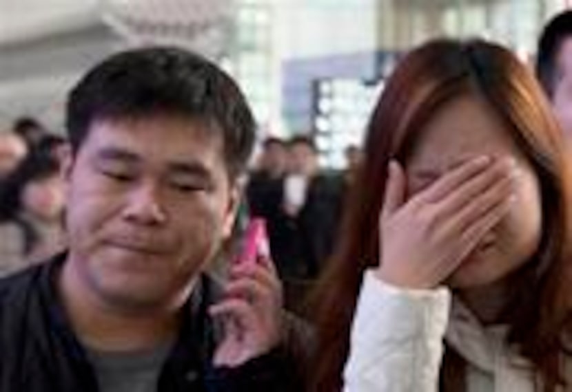 ALTERNATE CROP OF XHG102 A woman cries at the arrival hall of the International Airport in...