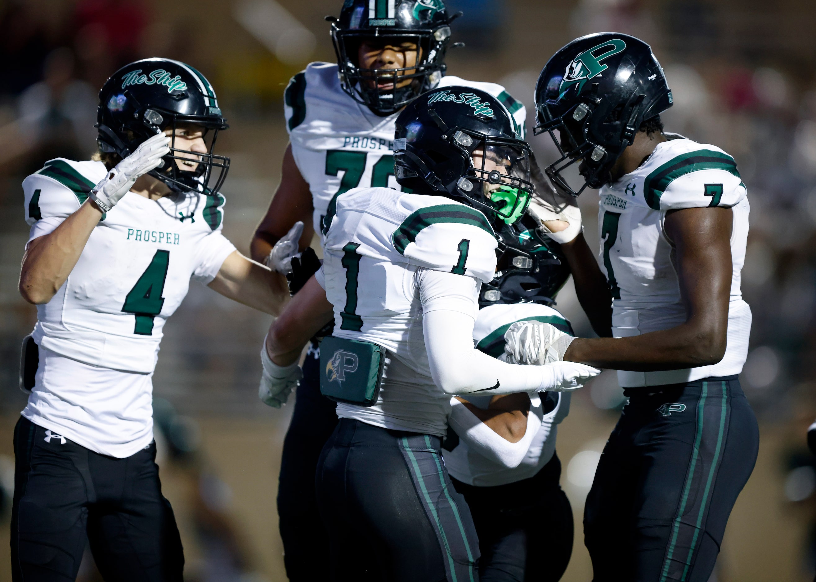 Prosper High’s Lathon Latiolais (1) is congratulated by teammates after his diving first...