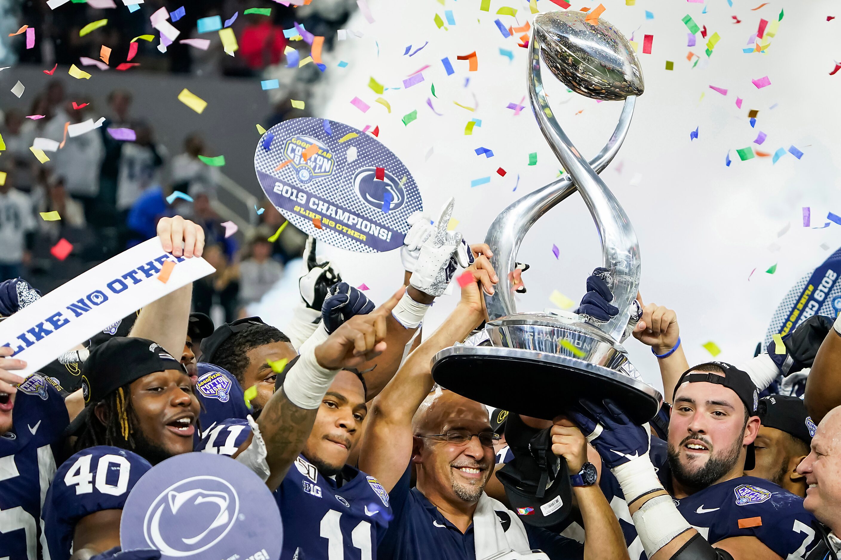 Penn State head coach James Franklin lifts the championship trophy with linebacker Micah...