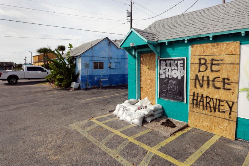A sign reading "Be Nice Harvey" was left behind on a boarded up business, Thursday, Aug. 24,...