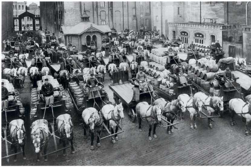 This image provided by the Pabst Mansion museum shows beer wagons and horse teams lined up...