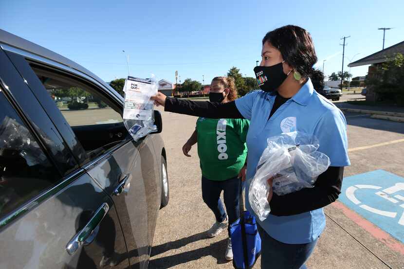 Astrid Aguiñaga of Dallas County Counts distributes census kits at the Pioneer Event Center...