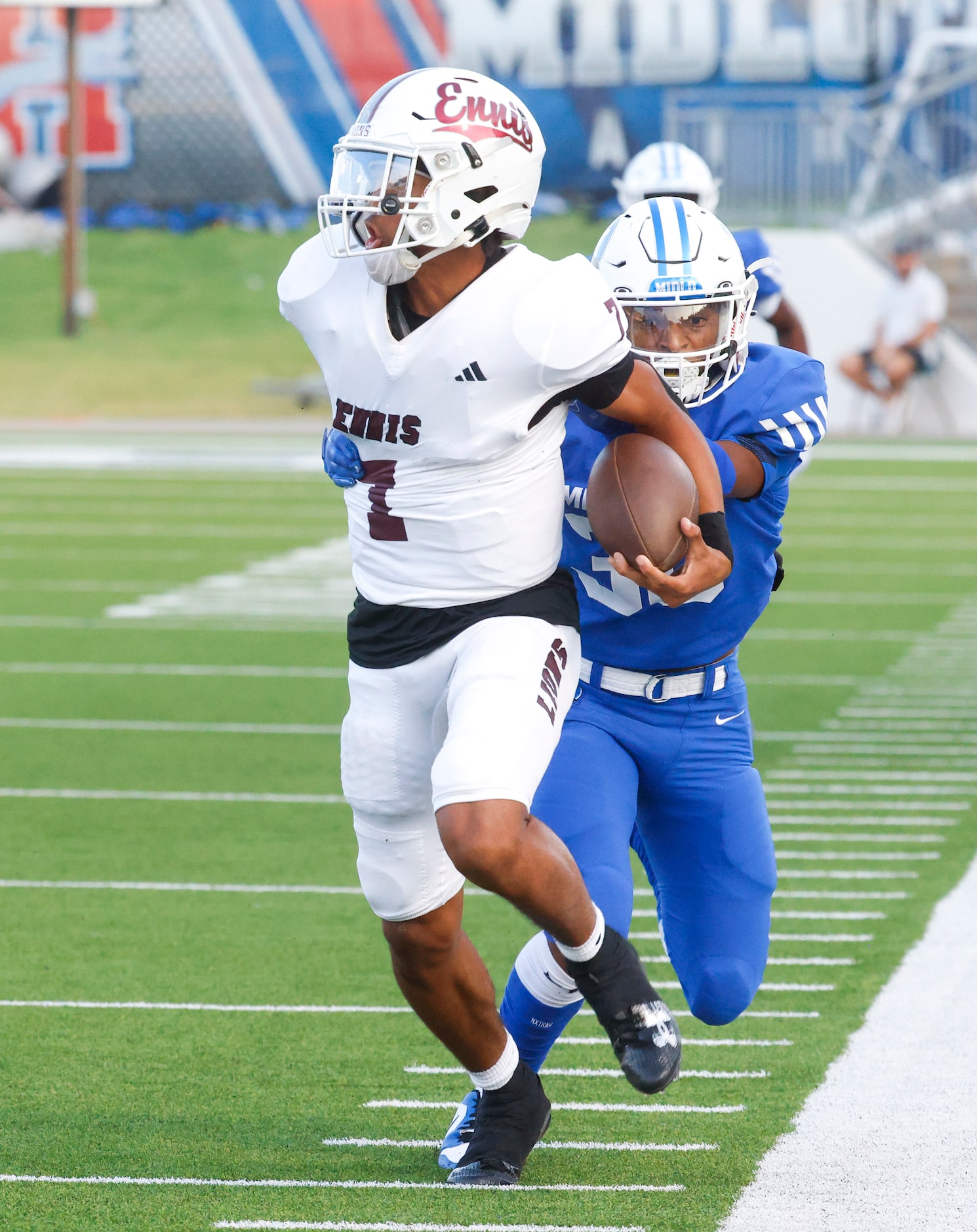 Ennis’ QB Wondame Davis Jr. (front) gets tackled by Midlothian’s Conlin Johnson (30) during...