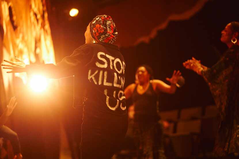 Raven Lawes, with "Stop Killing Us" emblazoned on the back of her jacket, in Stage West...