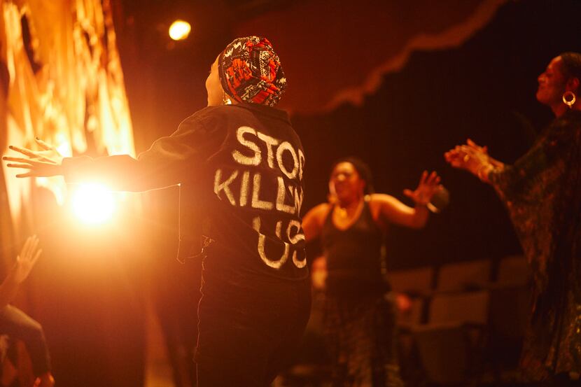 Raven Lawes, with "Stop Killing Us" emblazoned on the back of her jacket, in Stage West...