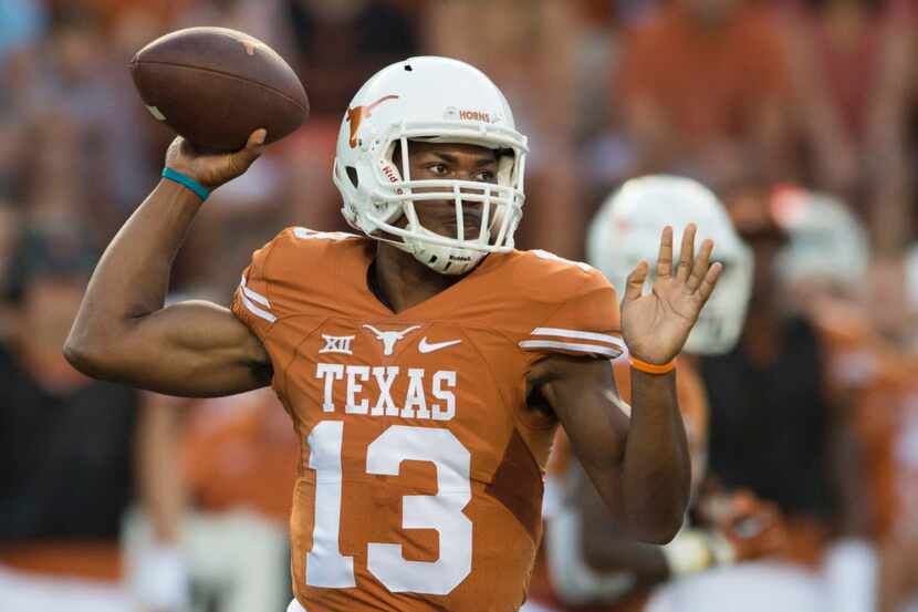 Jerrod Heard #13 of the Texas Longhorns drops back to pass against the California Golden...