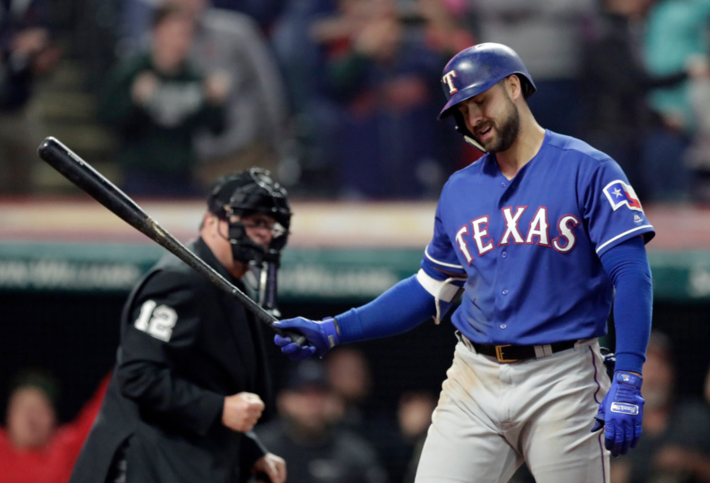 Texas Rangers' Joey Gallo reacts after striking out in the ninth inning of a baseball game...