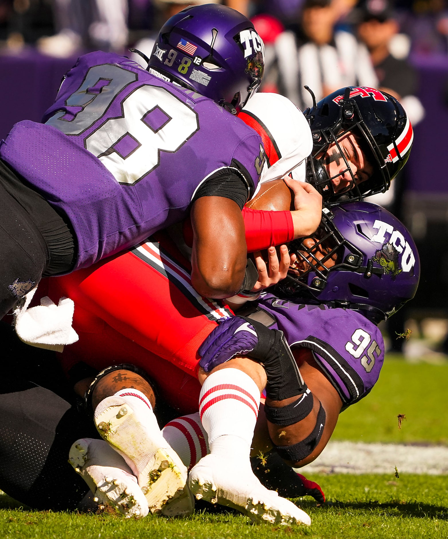 Texas Tech quarterback Behren Morton (2) is sacked by TCU defensive lineman Terrell Cooper...