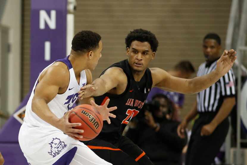 TCU guard Desmond Bane (1) is defended by Sam Houston State forward Kai Mitchell (20) during...