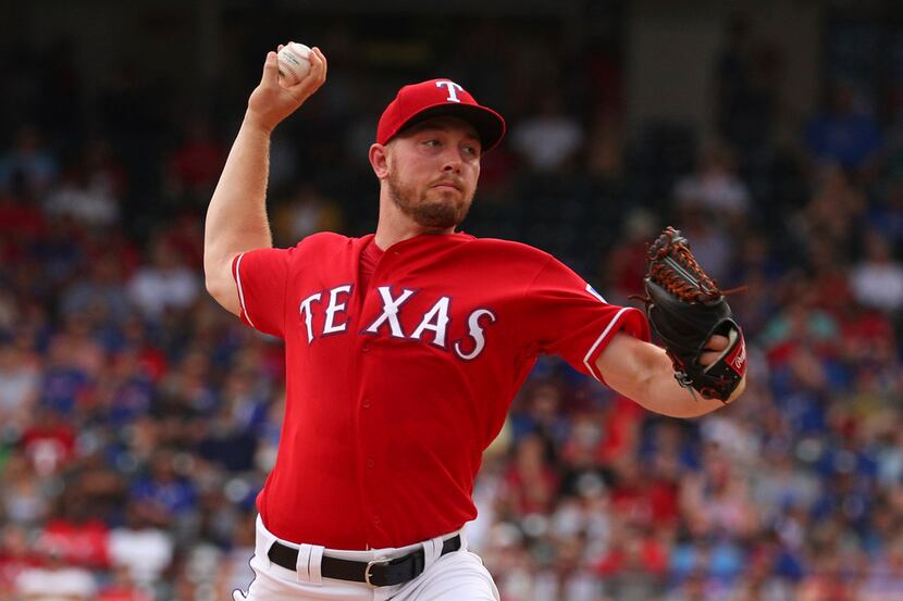 Texas Rangers starting pitcher Adrian Sampson delivers  in the second inning of a baseball...
