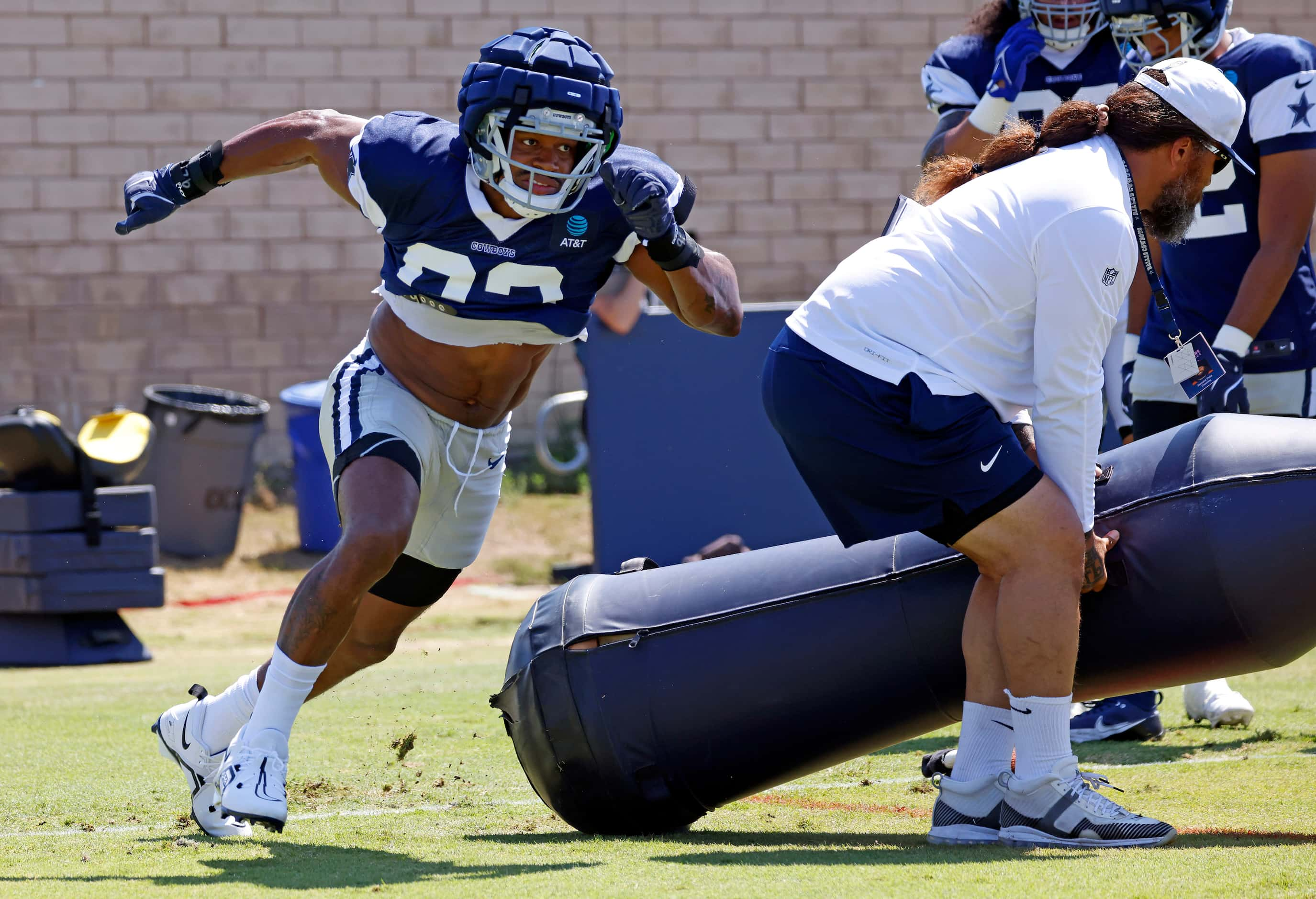 Dallas Cowboys newly singed defensive end Al-Quadin Muhammad (92) turns the corner on a...