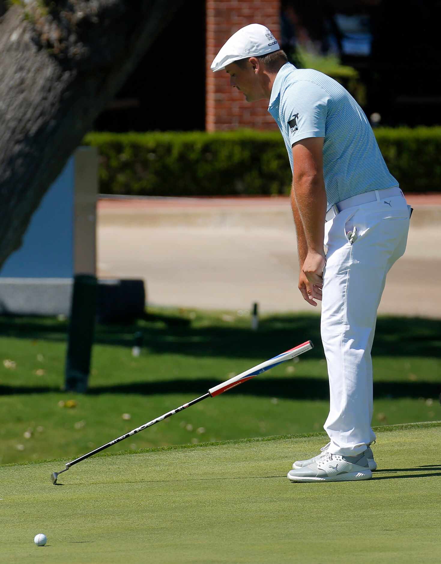 PGA Tour golfer Bryson DeChambeau
drops his putter as he misses a birdie putt on No. 18...