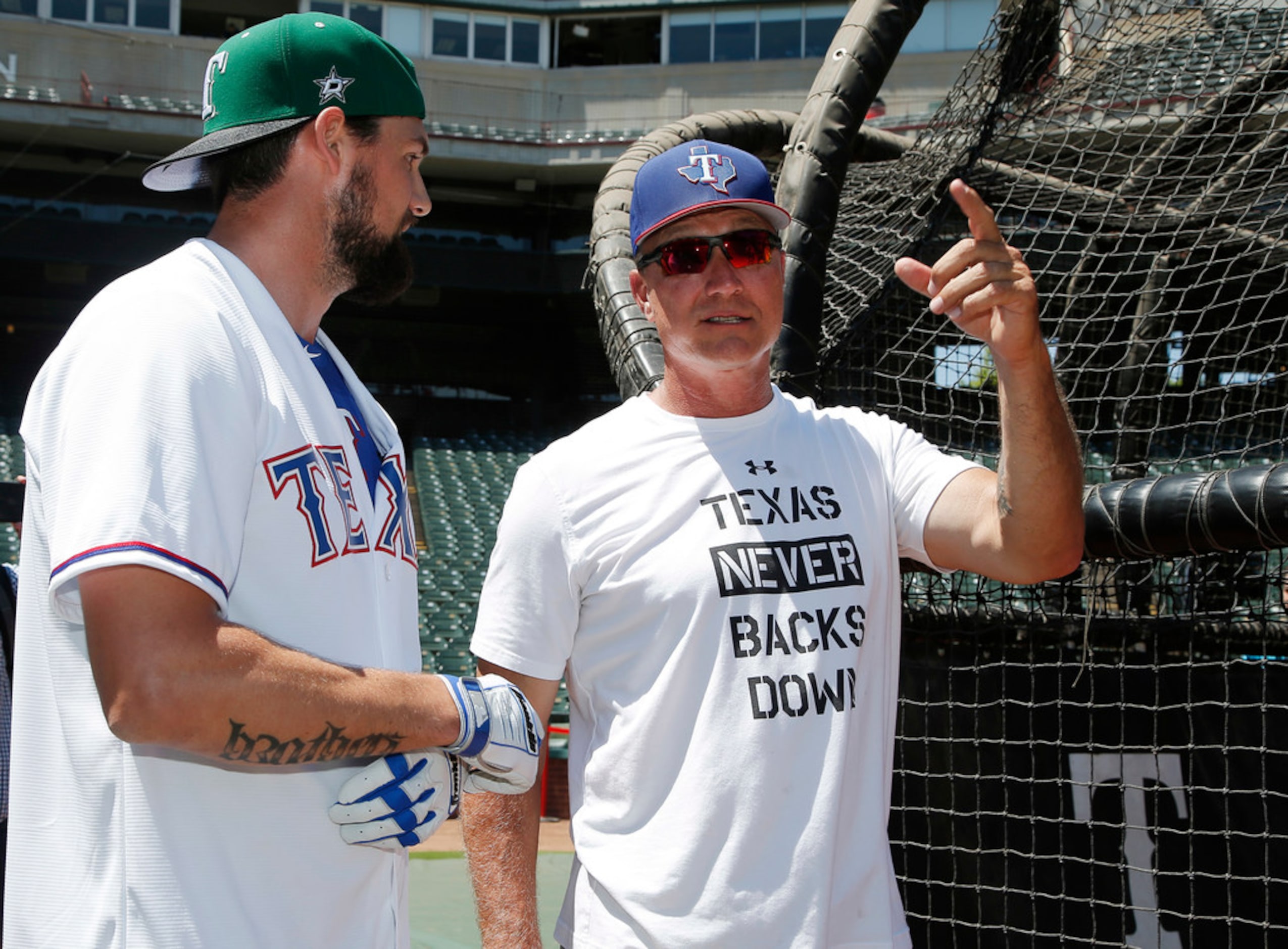 Dallas Stars captain Jamie Benn, left, and Texas Rangers manager Jeff Banister watch as...