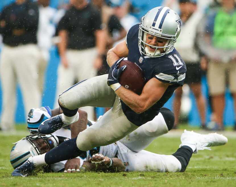 Dallas Cowboys wide receiver Cole Beasley (11) is brought down by Carolina Panthers...