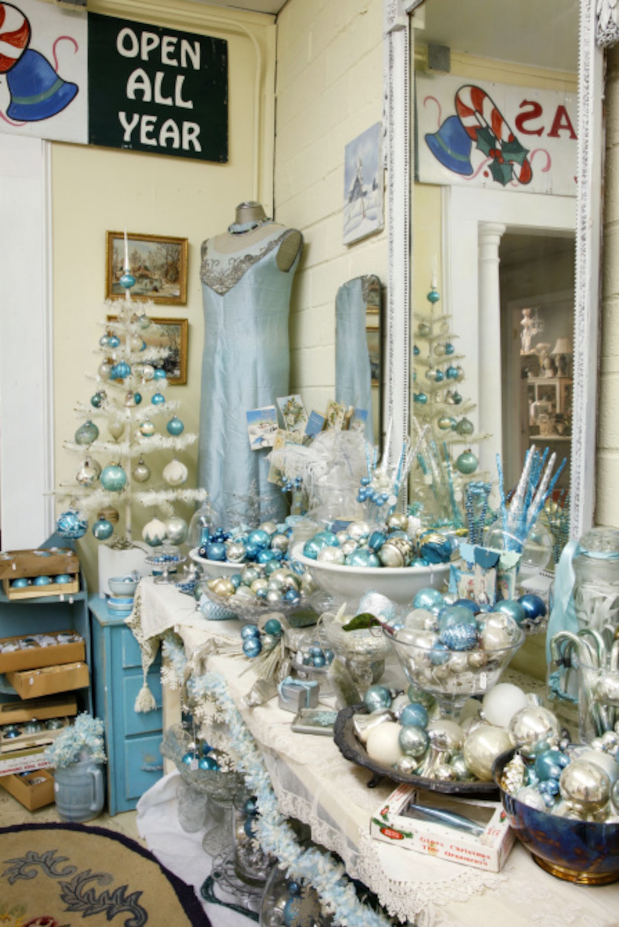 Turquoise and silver Christmas ornaments are displayed according to color, like other...