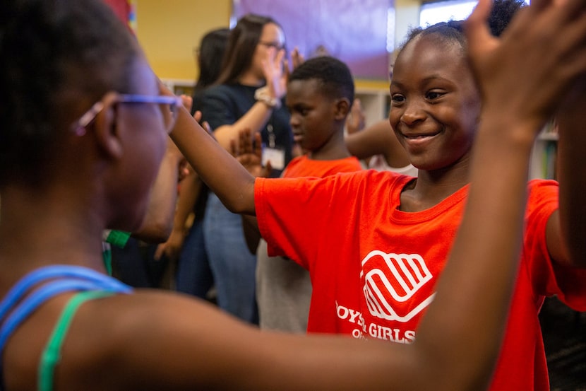 Aaliyah Wills, 9 (right), participates in a pantomime exercise during a theatre class...