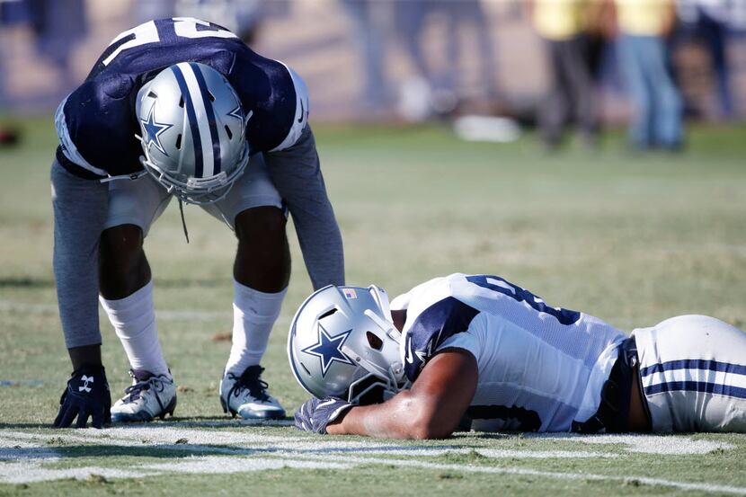 Dallas Cowboys tight end Rico Gathers (80) lays face down after a head to head collision...