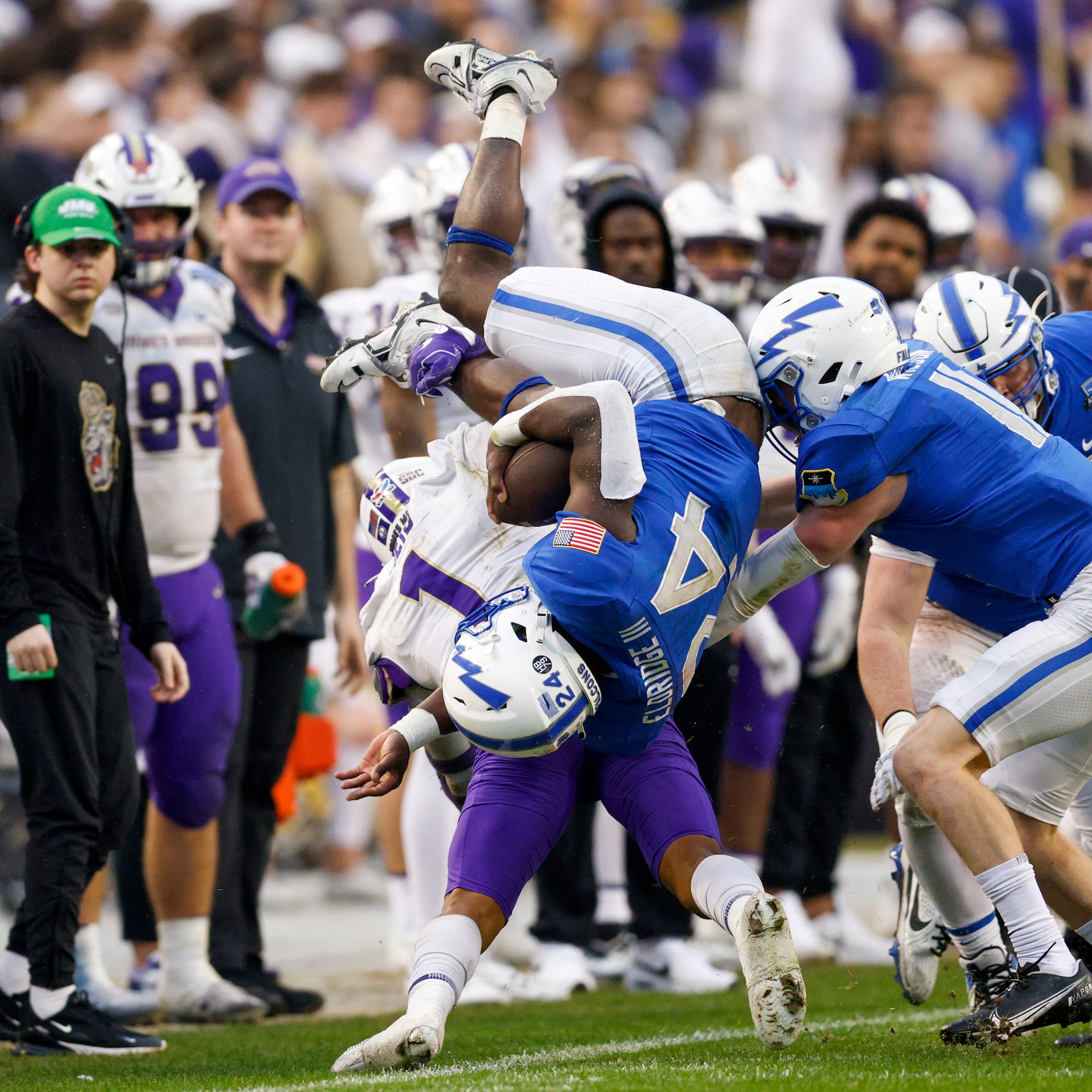 James Madison Dukes safety Que Reid (1) flips Air Force Falcons running back John Lee...