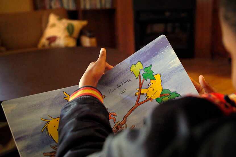 A 7-year-old resident at Jonathan's Place reads a book Thursday, March 31, 2016 in Garland,...