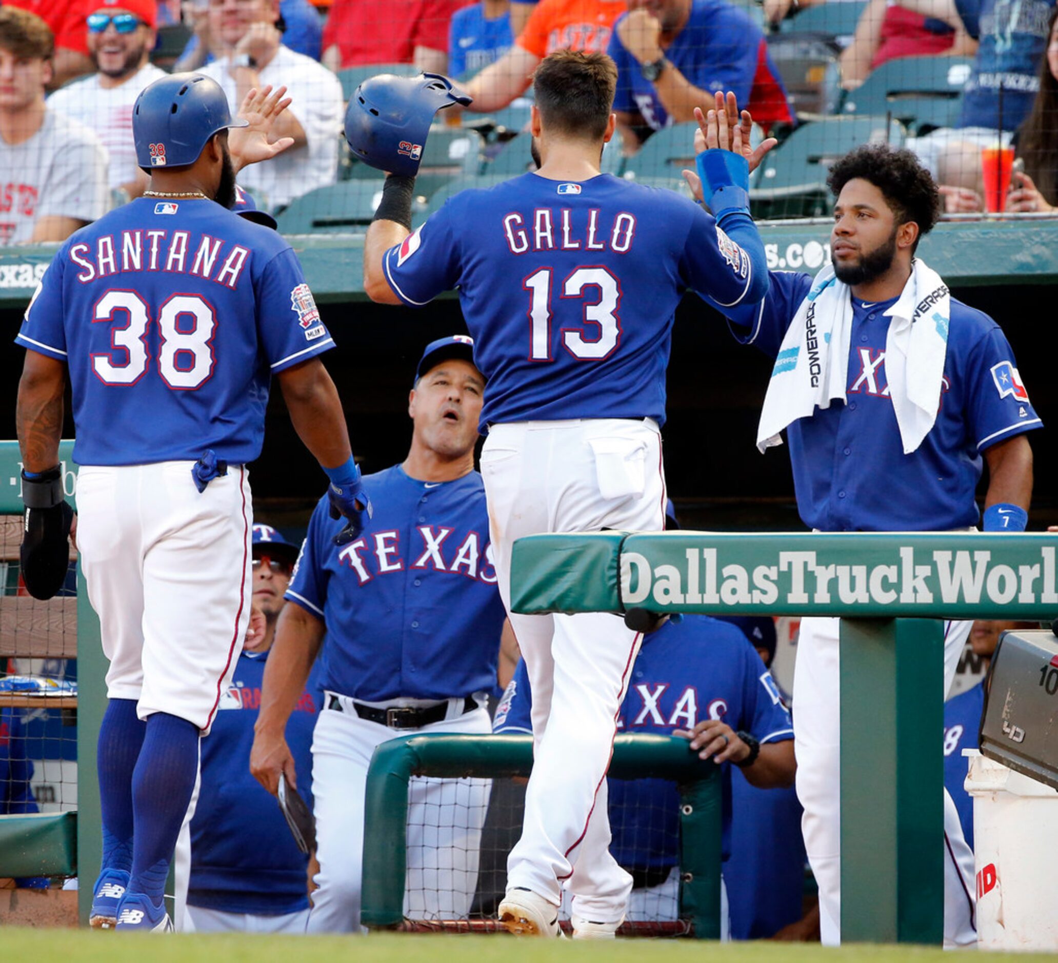 Texas Rangers Joey Gallo (13) and Danny Santana (38) are congratulated by Elvis Andrus after...