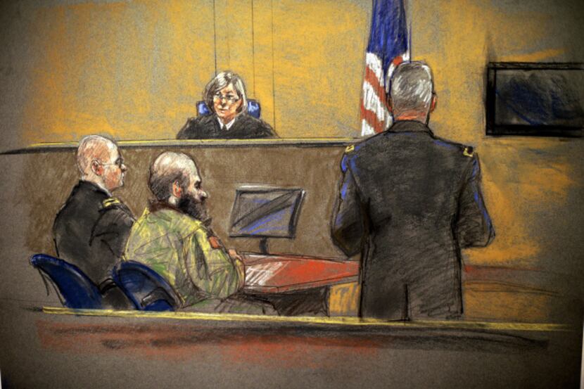 In this courtroom sketch, Maj. Nidal Hasan, center, sits before the judge, U.S. Army Col....
